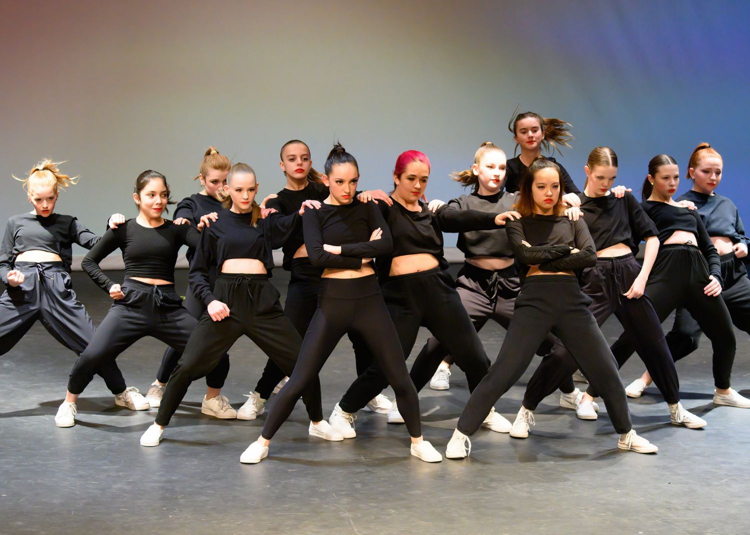 Hip hop dancers in black performing in formation